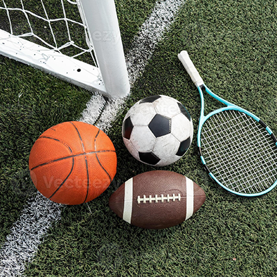a variety of sports equipment including an american football a soccer ball a tennis racket a tennis ball and a basketball photo