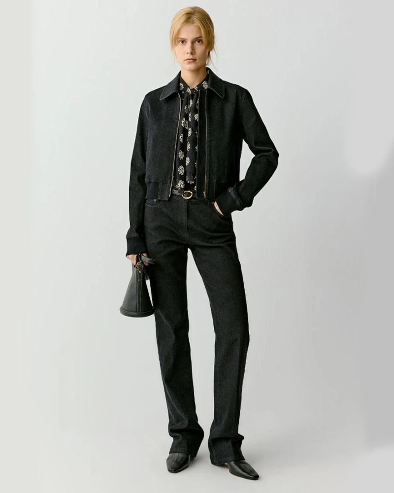 a woman in a black jacket and pants