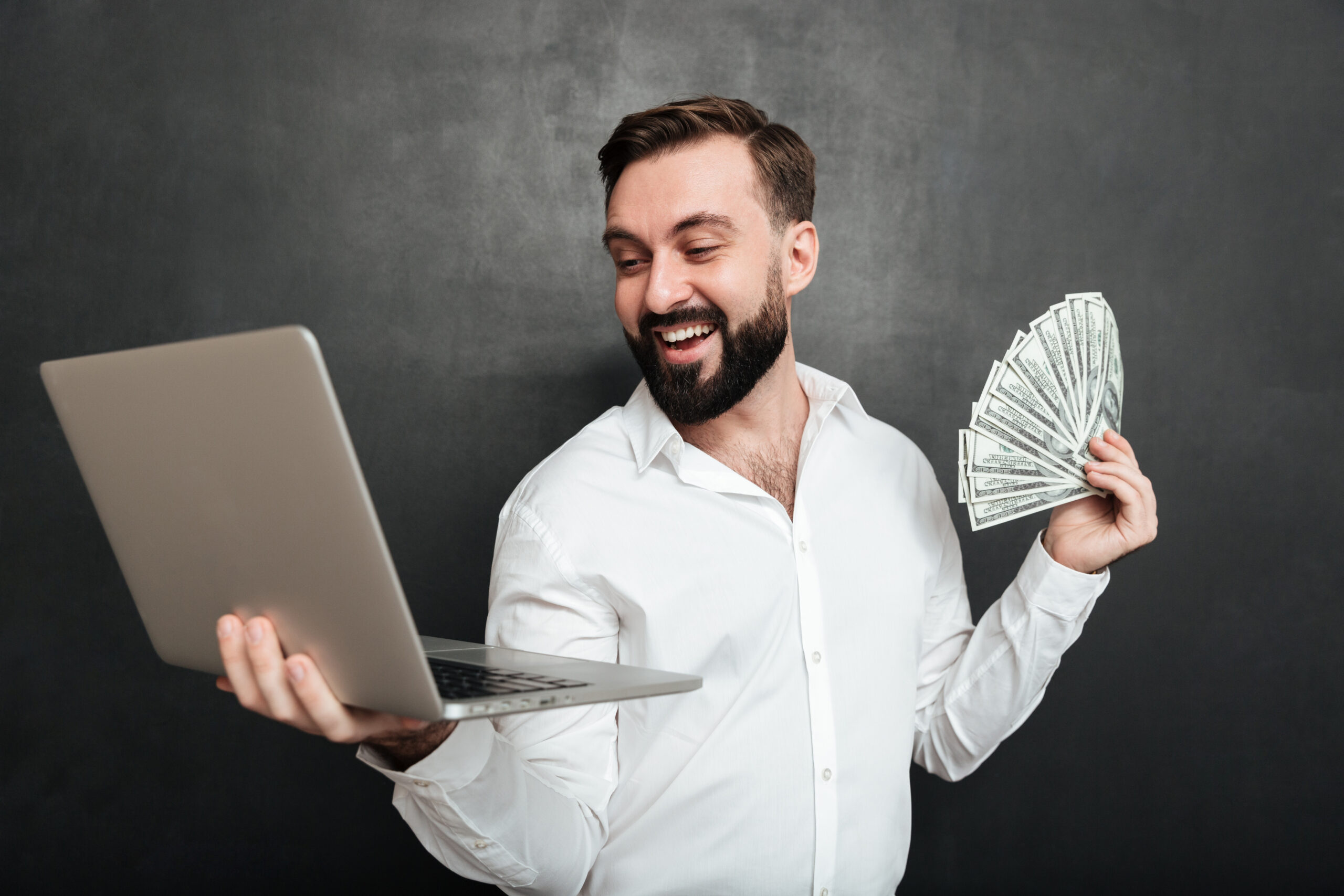 portrait successful businessman white shirt holding fan money dollar banknotes silver notebook both hands dark gray scaled